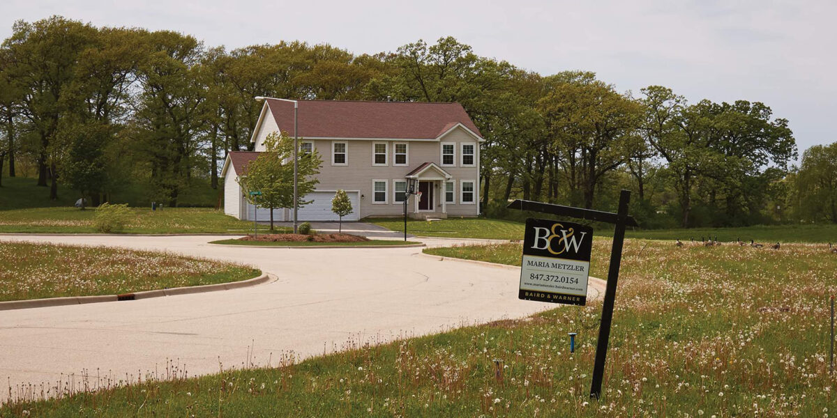 House in new development with for sale sign.